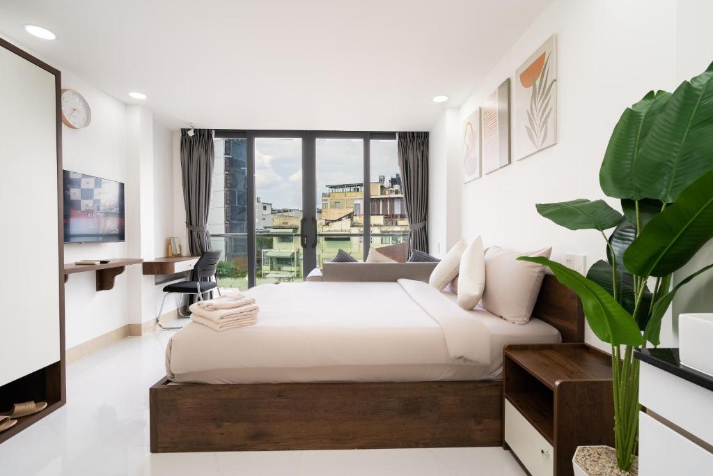 Bright queen studio with a work desk and balcony view at Ekomo Home 95 - Metro Ben Thanh